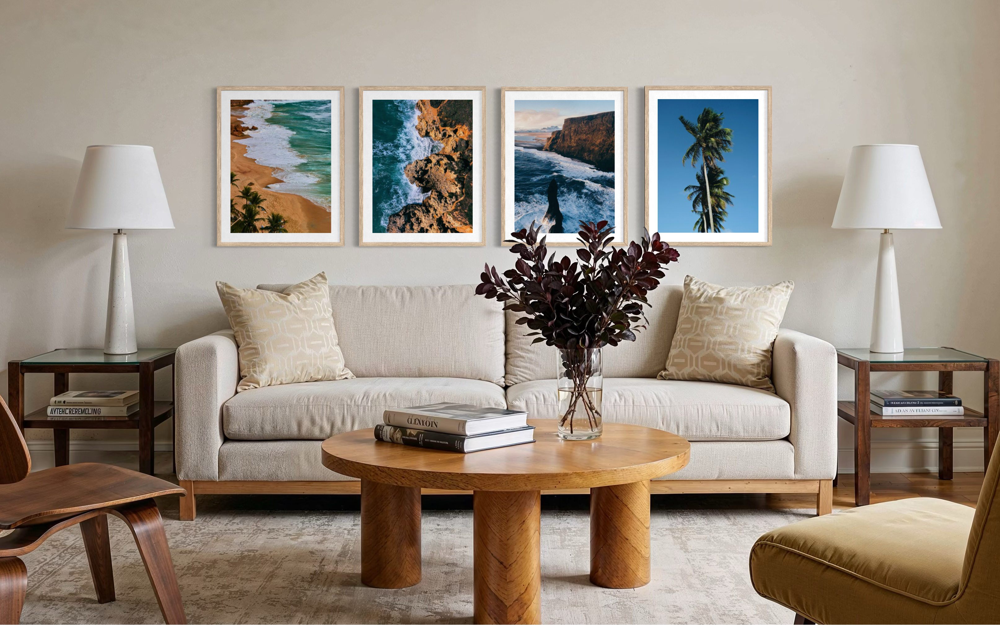 A styled living room featuring a set of four framed vertical landscape photographs hanging in a row above a light beige sofa. The frames contain beach and coastal scenes with turquoise water, white surf, sandy shores, and palm trees.